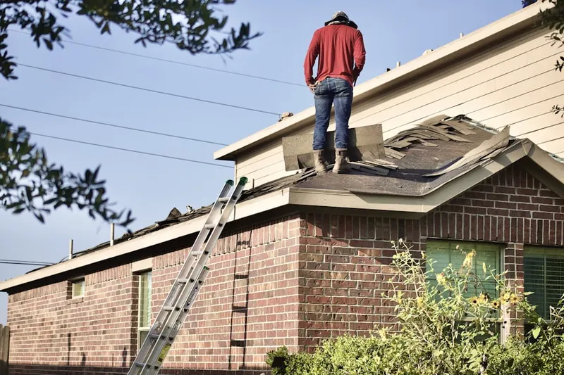 Professional roofer working on a residential roof in Rockridge Forest